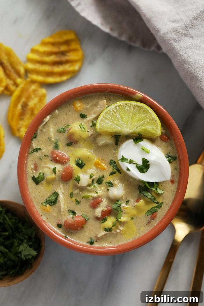 white bean chicken chili in a bowl topped with greek yogurt.
