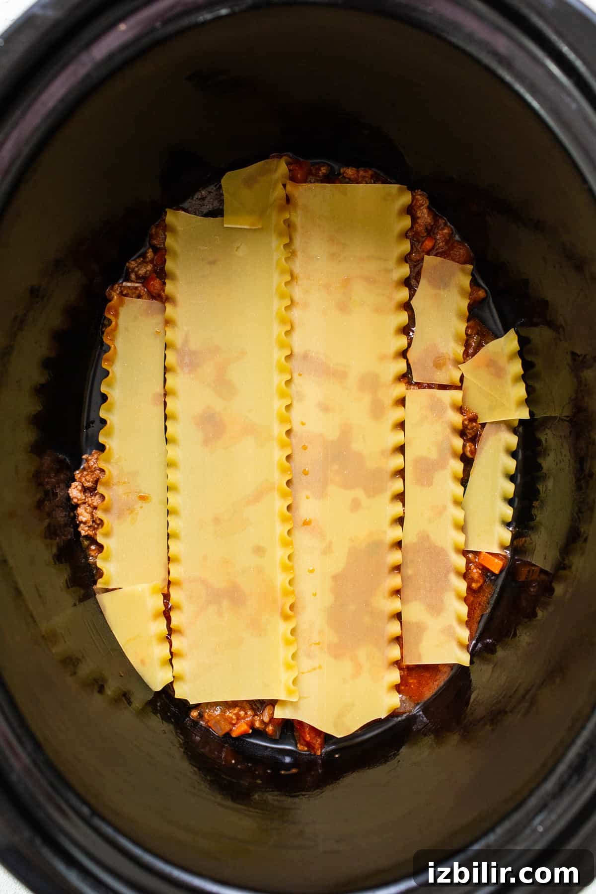 Crockpot Lasagna Recipe: Creamy Slow Cooker Lasagna 3 A crock pot filled with pasta and sauce.