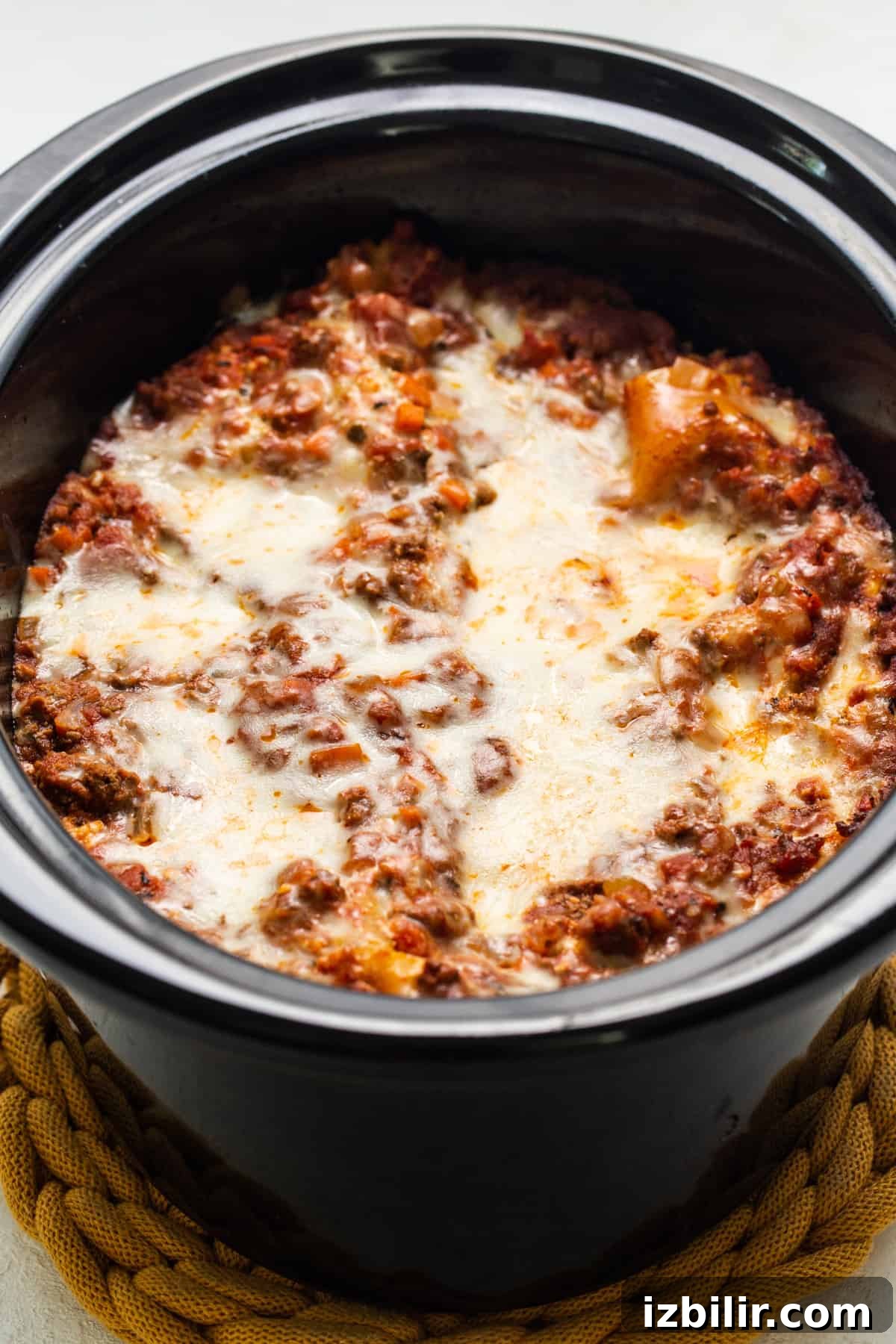 Crockpot Lasagna Recipe: Creamy Slow Cooker Lasagna 4 A close up of a pot of food on a table.