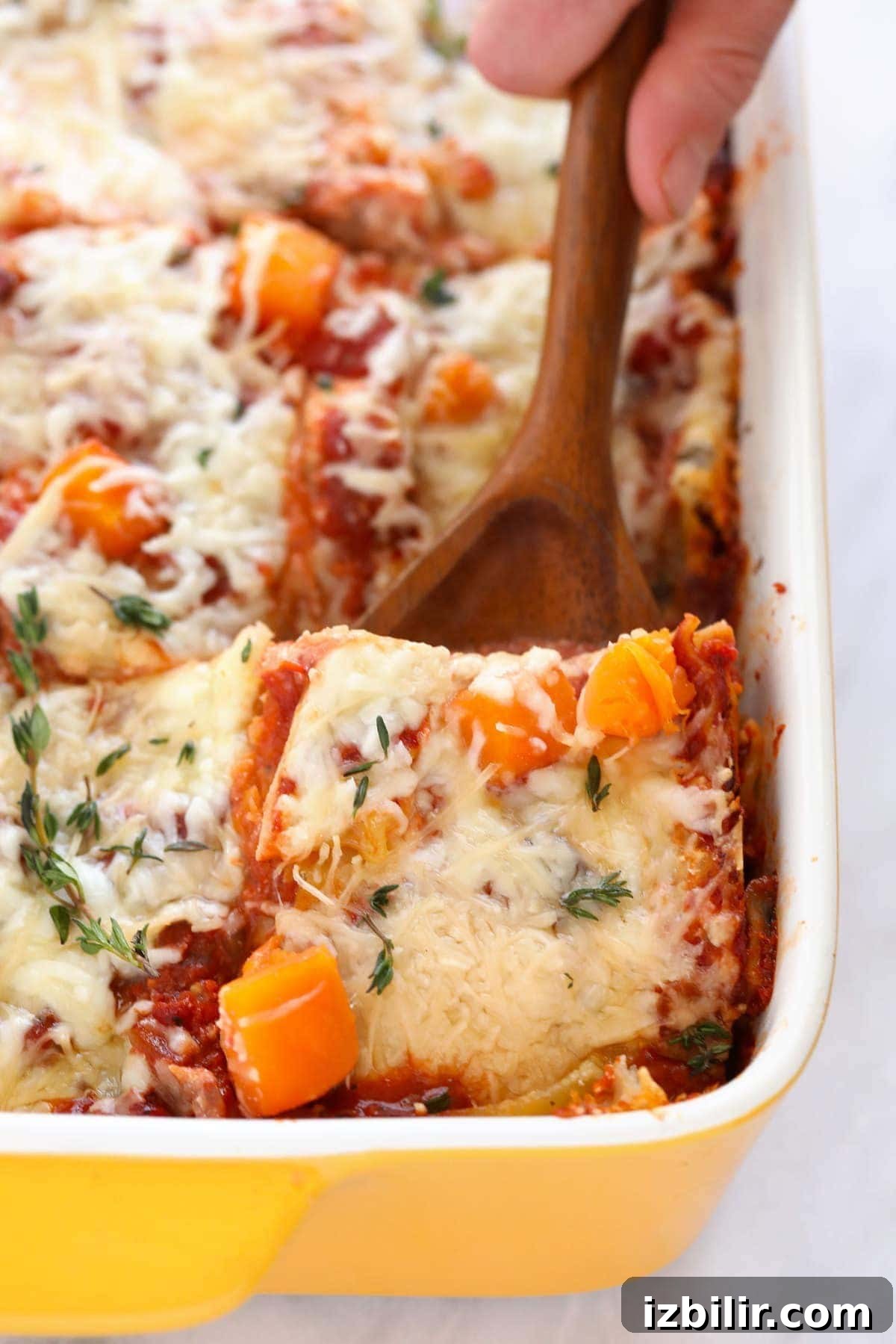 A spatula scooping out a piece of lasagna.
