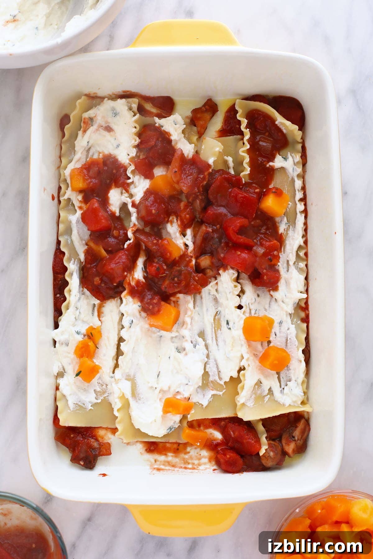 Building a butternut squash lasagna in a 9x13 pan.