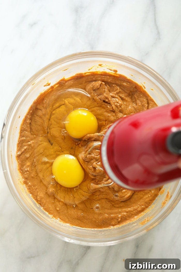 pumpkin cheesecake bar filling being mixed in a bowl
