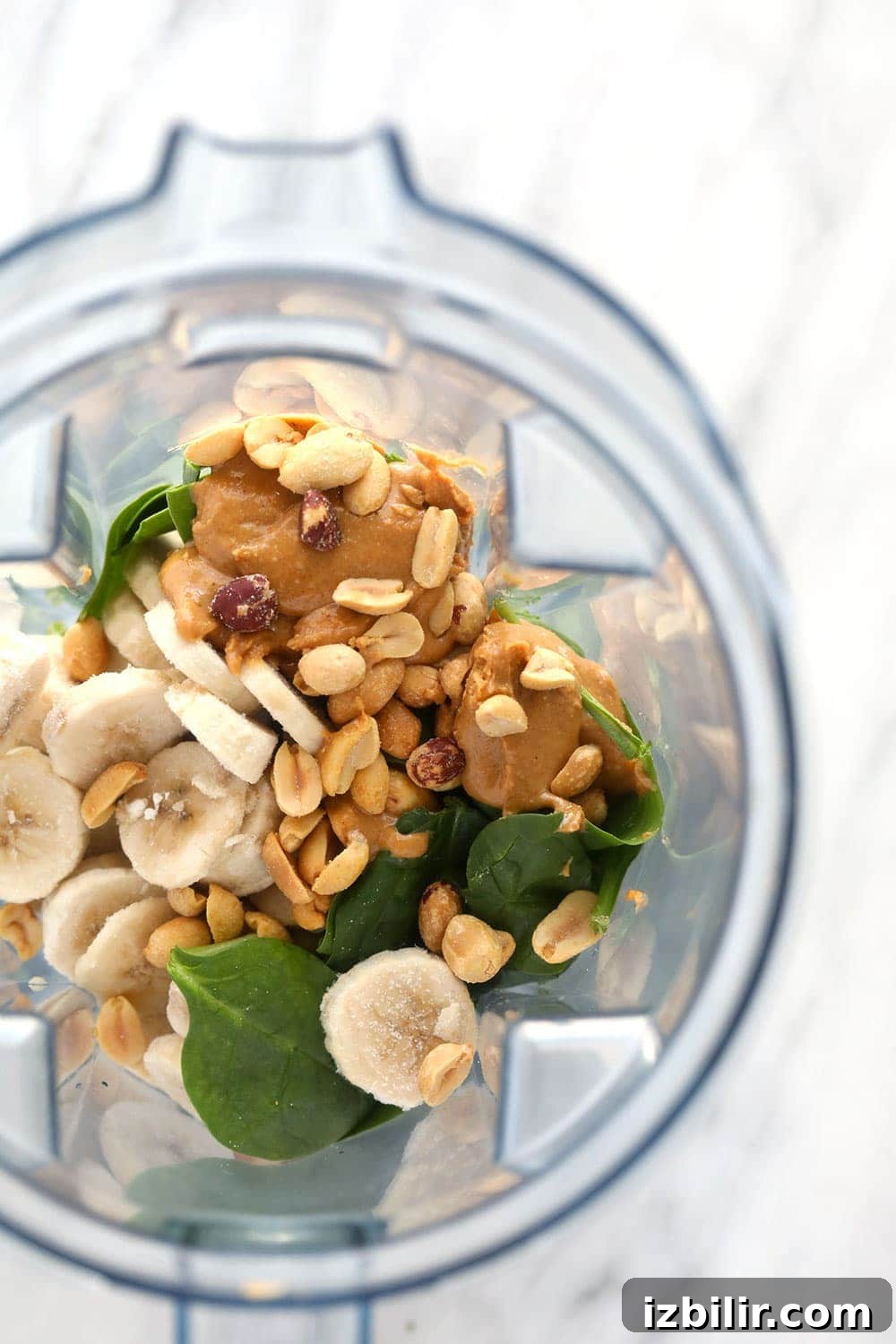 Ingredients for the peanut butter green smoothie in a blender