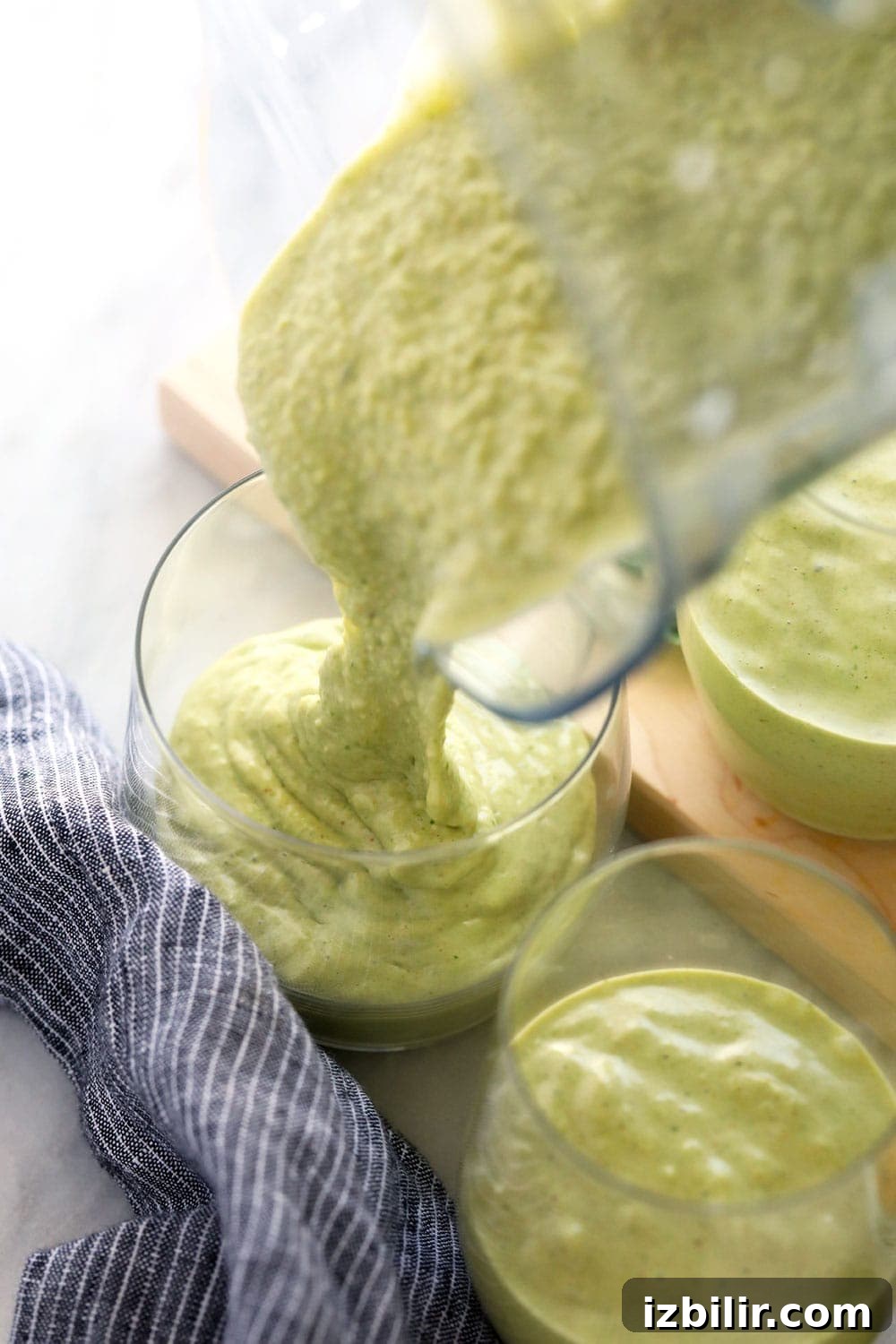 Pouring the smoothie into a glass