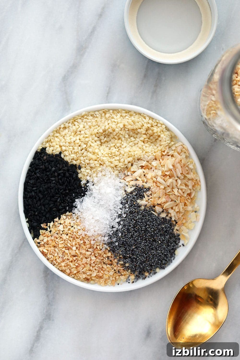 Everything Bagel Seasoning needs to be the new all-purpose seasoning that you put on everything! It's made with just 6 ingredients and very addicting. spices on plate