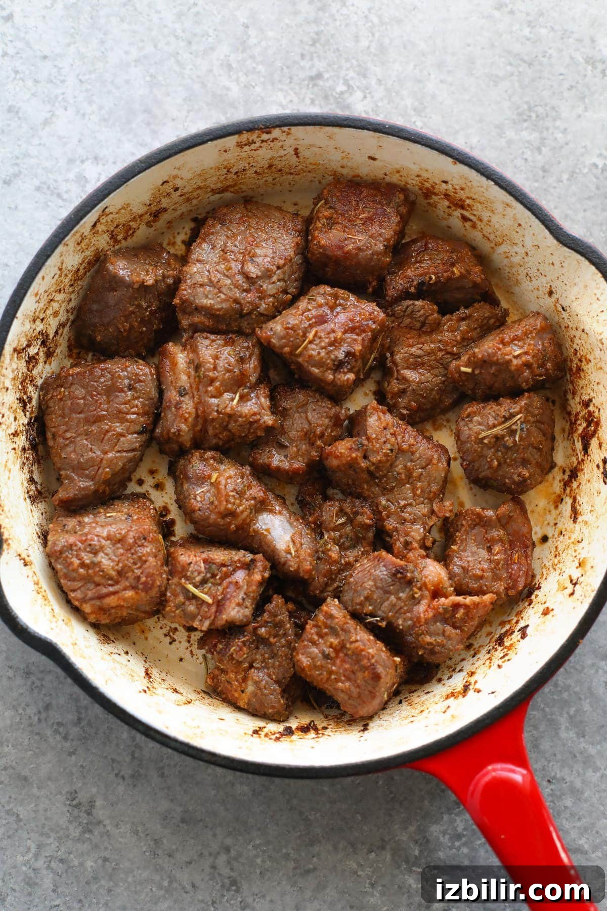 beef stew meat being browned in in a skillet