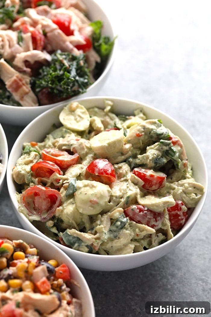 This creamy pesto chicken salad makes the perfect healthy lunch or easy weeknight dinner. It's easy to make and is packed with protein! Pesto chicken salad in a bowl