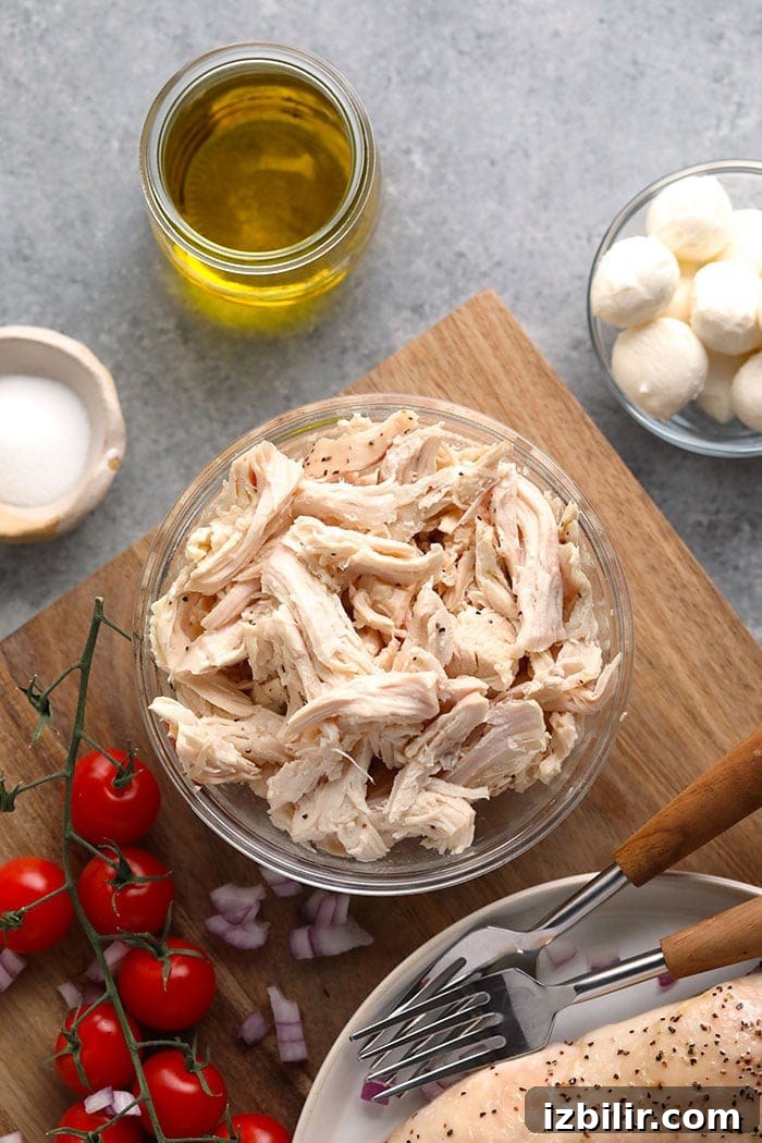 This creamy pesto chicken salad makes the perfect healthy lunch or easy weeknight dinner. It's easy to make and is packed with protein! Shredded chicken in a bowl.