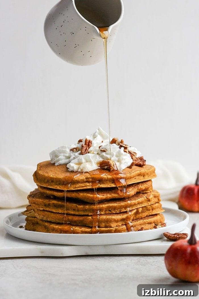 pouring syrup on pumpkin pancakes.