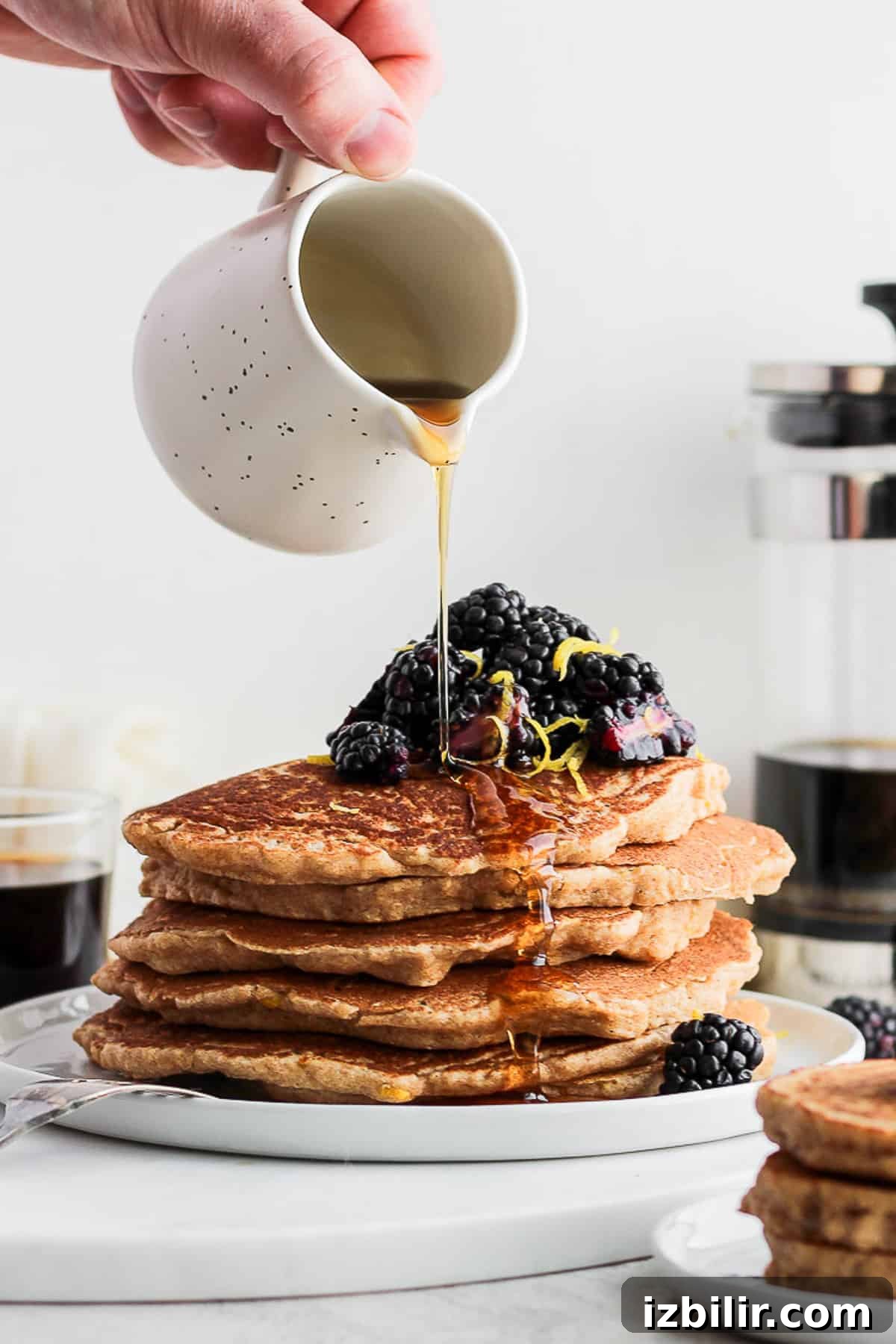 Fluffy Lemon Ricotta Pancakes Recipe 2 pouring syrup on pancakes