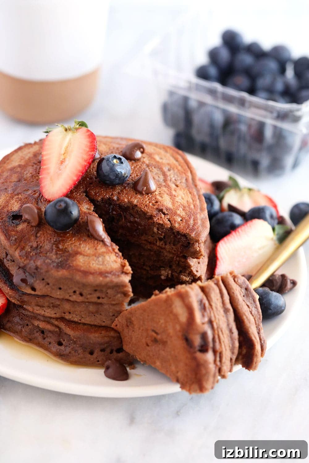 Stack of healthy chocolate chocolate chip pancakes 3 chocolate chocolate chip pancakes on a plate