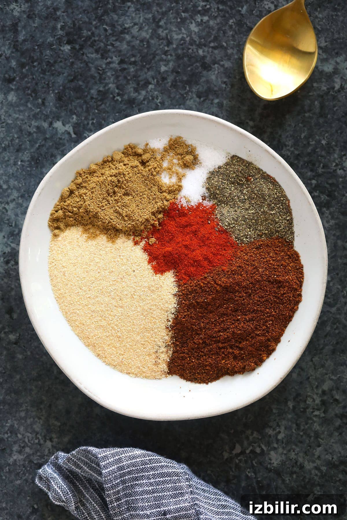 Use this homemade chili seasoning in your next batch of chili. This chili seasoning recipe is the perfect blend of smokey and savory and only requires 6 total ingredients. chili spices on plate