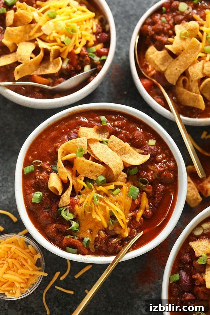 bowl of beef chili with cheese on top.