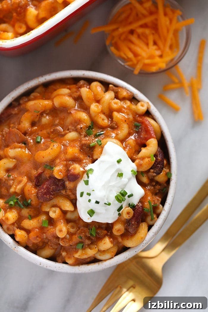 Serve chili mac with a dollop of Greek yogurt or sour cream Chili mac in a bowl with Greek yogurt