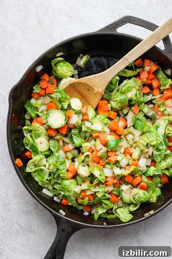 Sautéed veggies in a skillet for cornbread stuffing