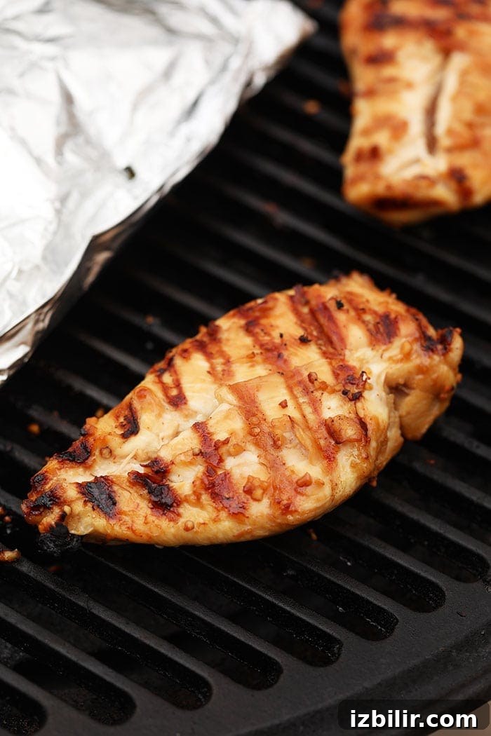 Grill chicken until cooked through Grilled chicken breast on the grill