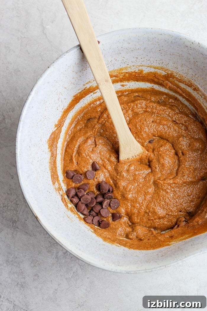 Mixing pumpkin bread ingredients healthy pumpkin bread ingredients in a bowl.