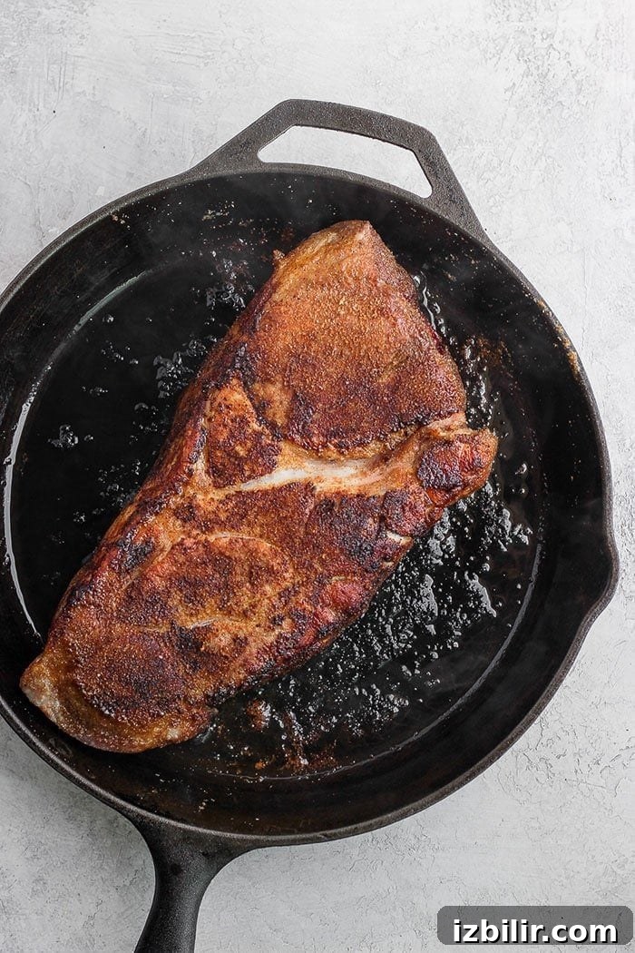 Dry rubbed pork in skillet dry rubbed pork in a cast iron skillet
