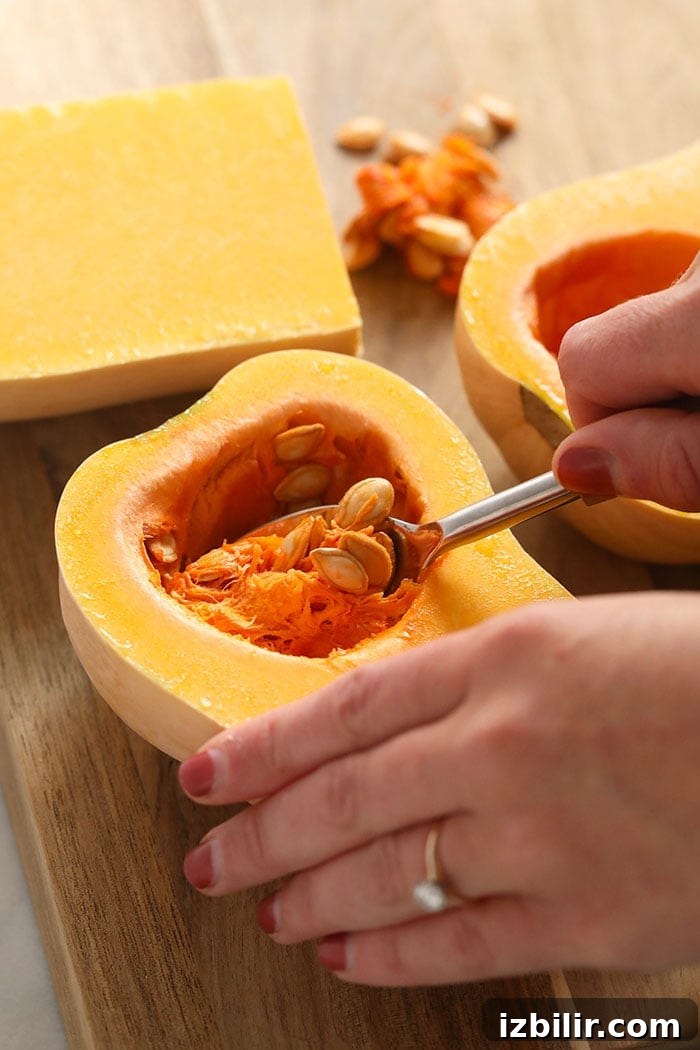 How to Make Creamy Butternut Squash Puree 3 scooping out the seeds from a butternut squash