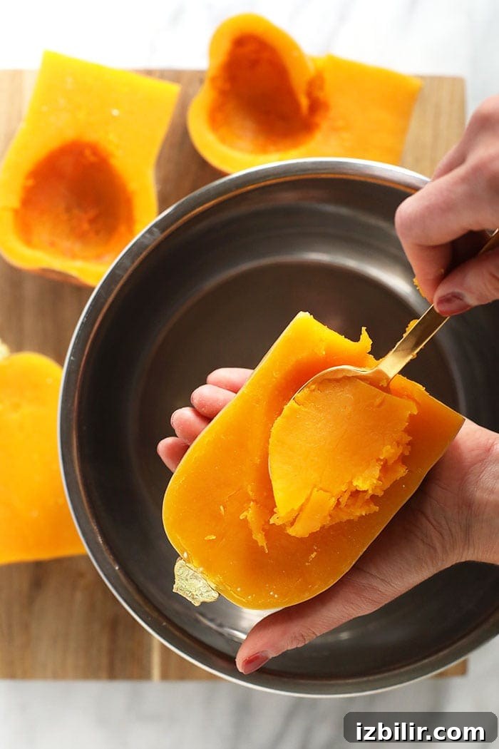 How to Make Creamy Butternut Squash Puree 4 scooping out the butternut squash meat from the roasted butternut squash