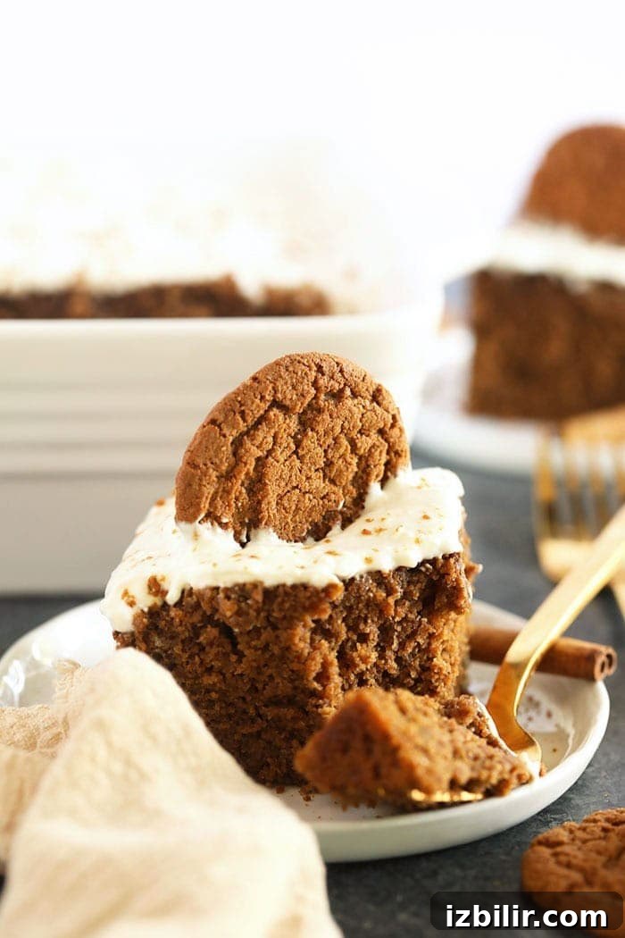 This classic Gingerbread Recipe is calling your name this holiday season! Perfectly spiced and sweet, and topped with a delicious lightened-up cream cheese frosting. Dessert is served! slice of gingerbread on a plate