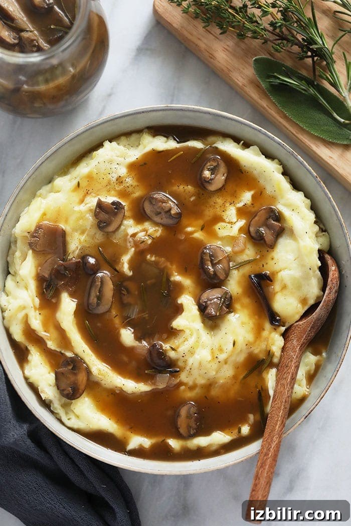 Vegetarian Mushroom Gravy over mashed potatoes in a bowl.
