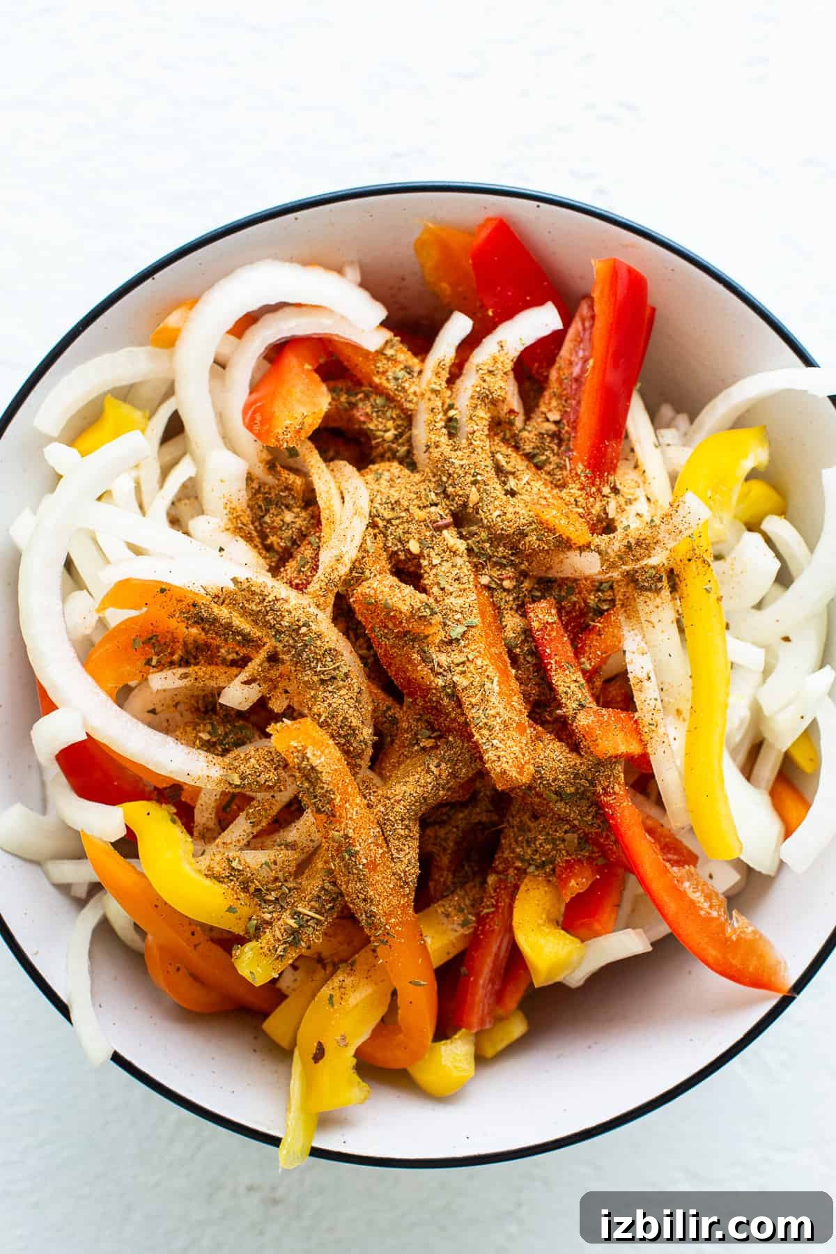 Slow Cooker Chicken Fajitas with Bell Peppers 4 A bowl filled with peppers and onions.