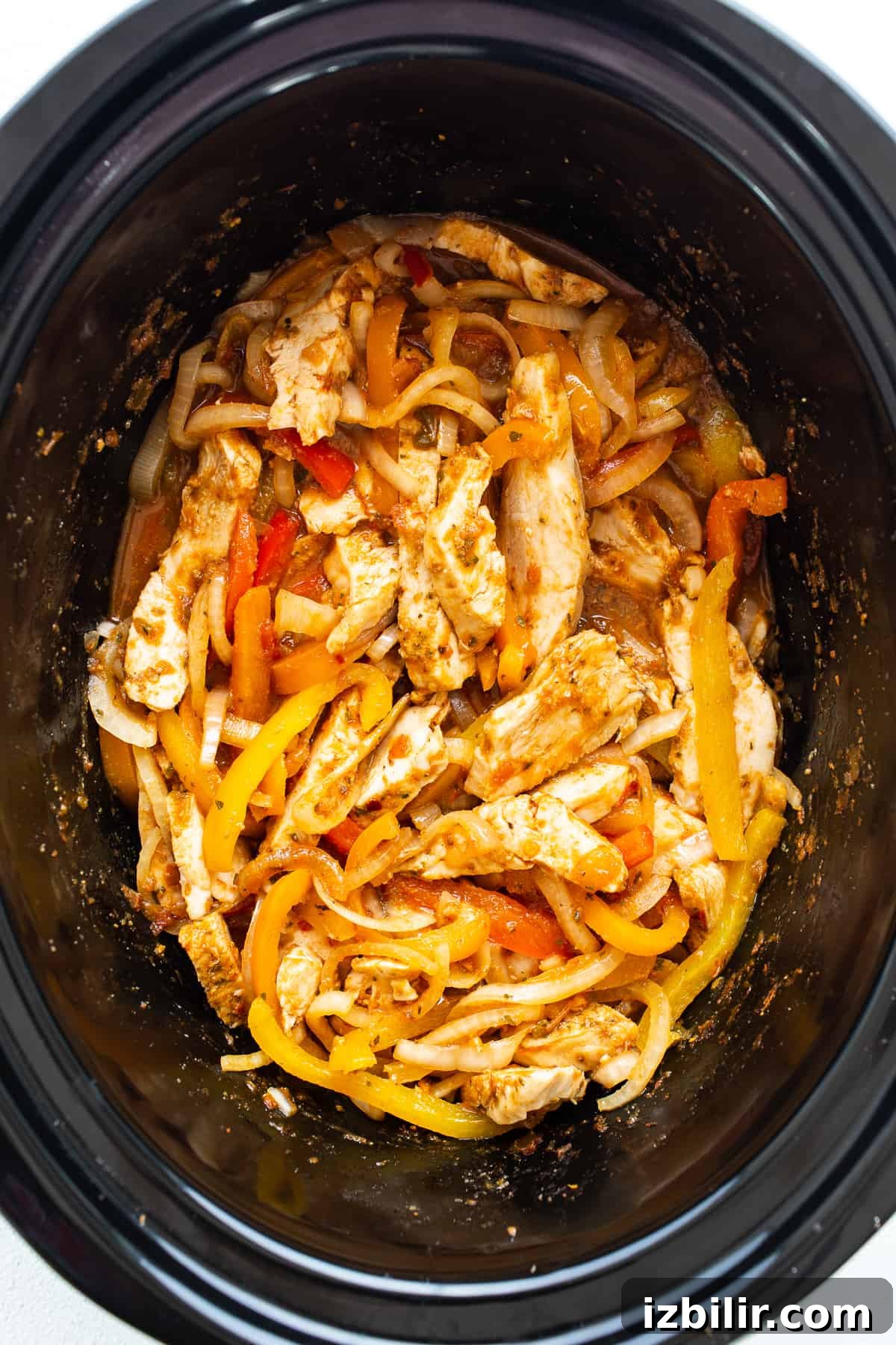 Slow Cooker Chicken Fajitas with Bell Peppers 6 Chicken and peppers in a slow cooker.