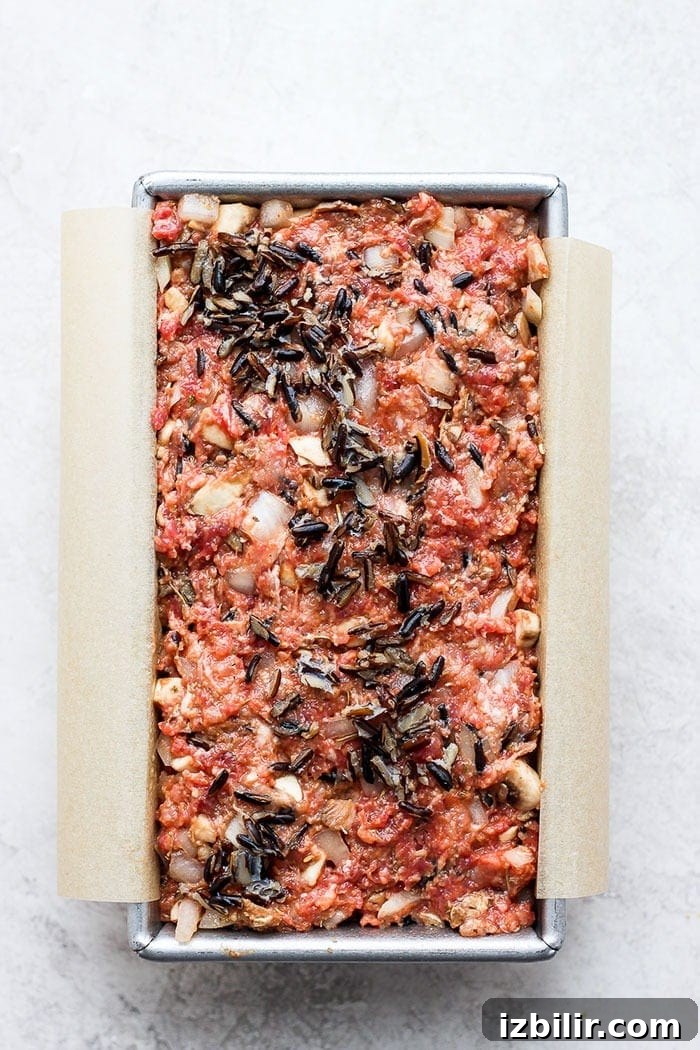 wild rice meatloaf in a loaf pan ready to be baked