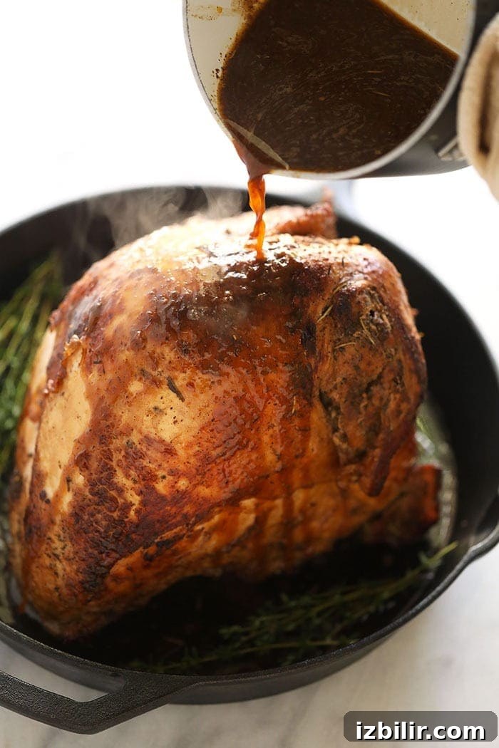 Pouring white wine sauce over the turkey