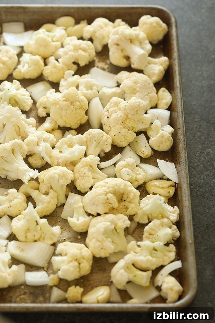 Cauliflower, onion, and garlic on a pan