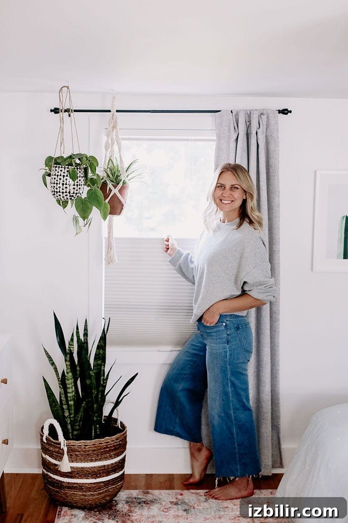 Our custom modern window treatments are here, and I couldn't be more excited to share the big reveal with all of you! Lee pulling shade down on window treatment