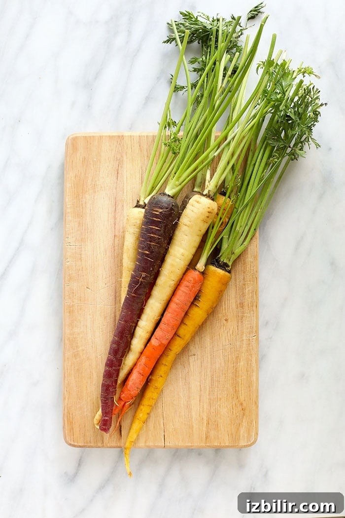 Carrots ready to roast multi-colored carrots on a cutting board