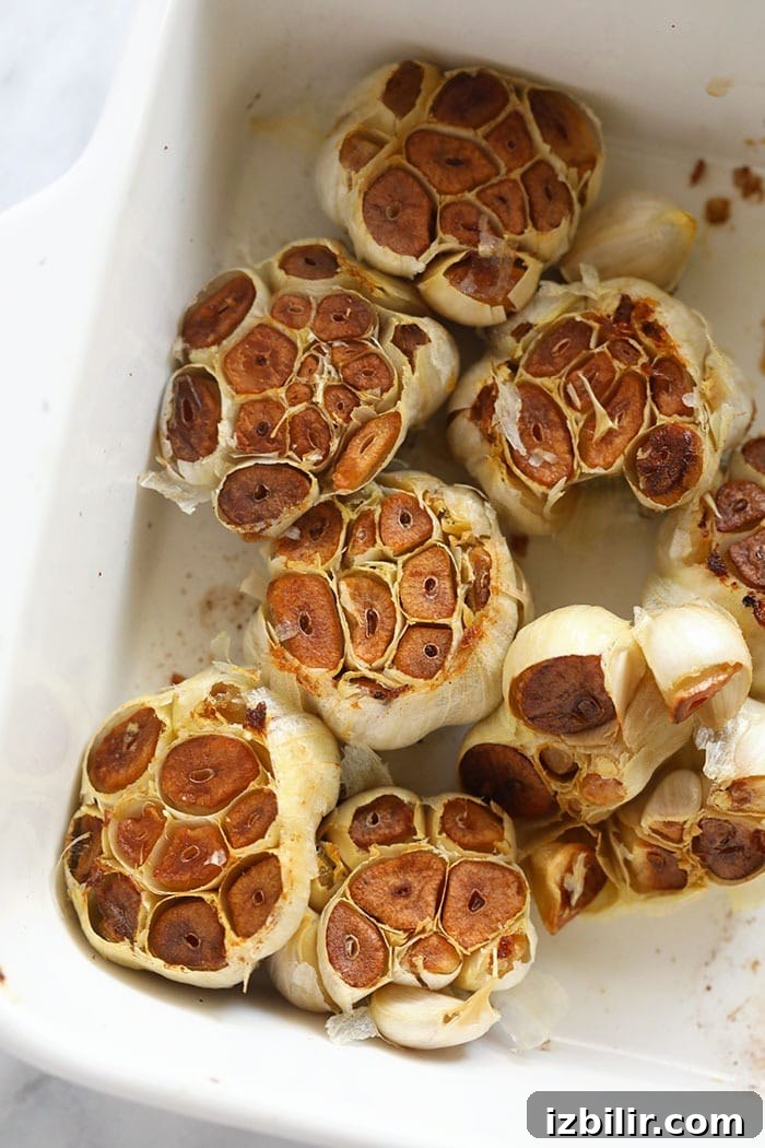 Roasted garlic bulbs in a baking dish roasted garlic bulbs in a baking dish