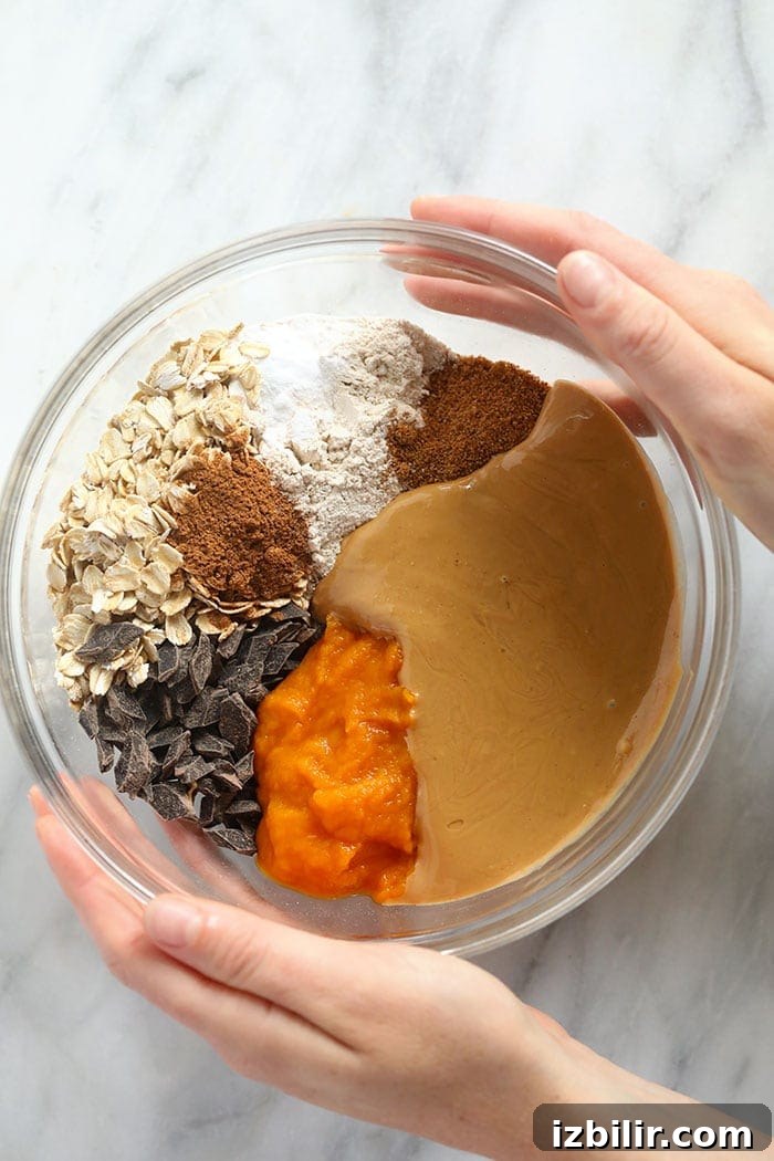 bowl of ingredients for pumpkin oatmeal cookie bars