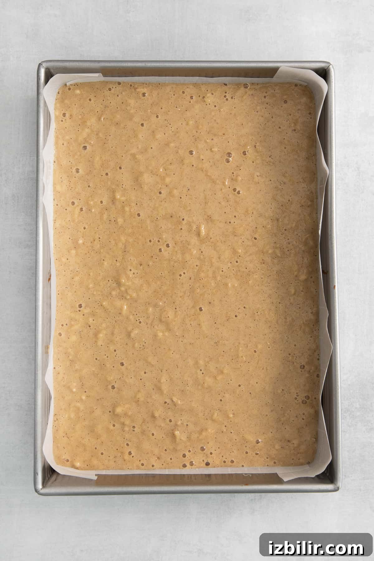 Apple cake batter in a pan.