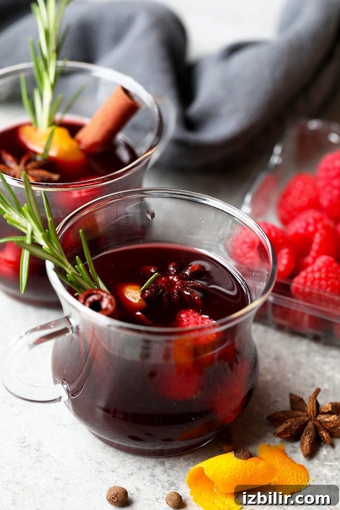 Mulled wine in a mug with rosemary