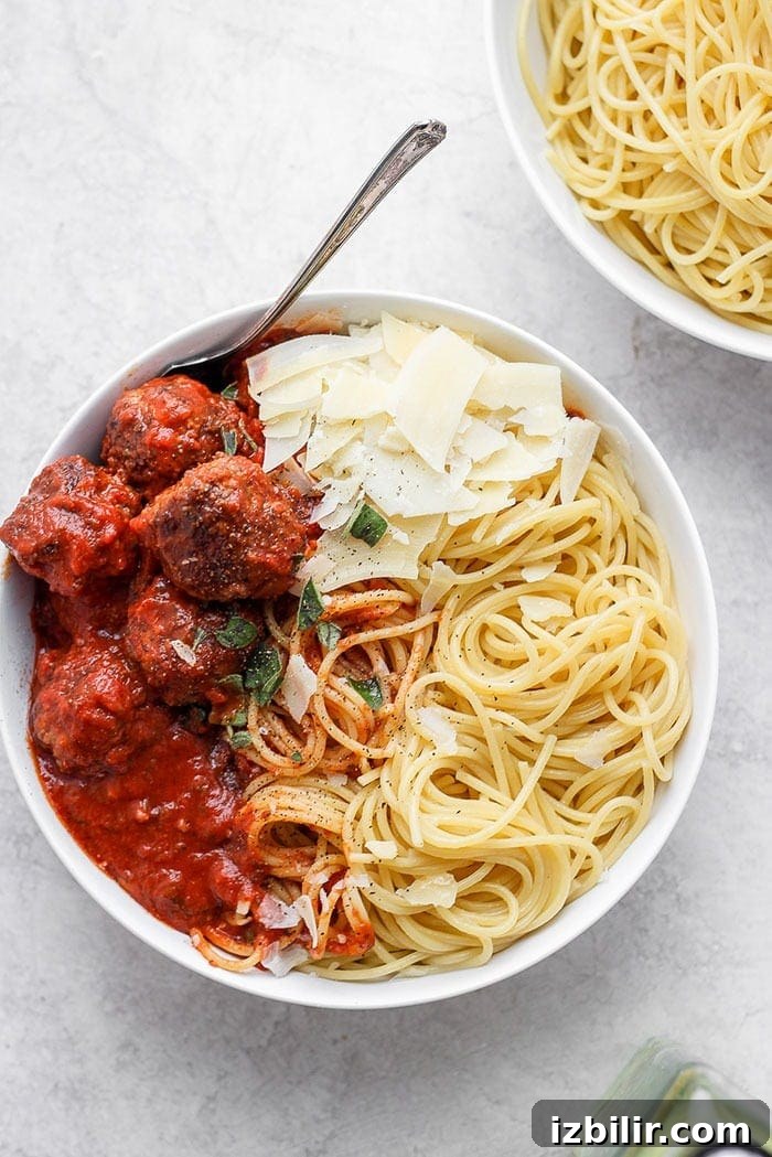 Italian meatballs and pasta is a crowd-pleasing, kid-friendly dinner idea. This truly is the best meatball recipe and it’s simply made with ground beef, breadcrumbs, parmesan, and your favorite marinara sauce! Spaghetti and meatballs on plate.