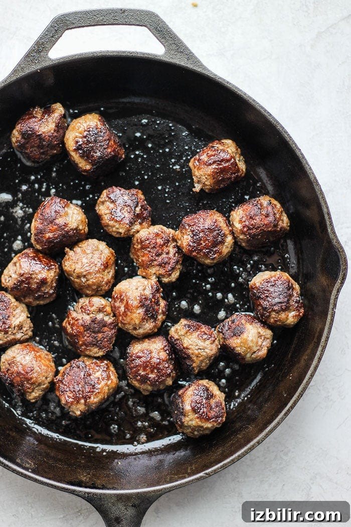 The best Italian meatballs on the internet made with just a few simple ingredients! Serve these over a bed of pasta and your favorite noodle! Italian meatballs in cast iron skillet.