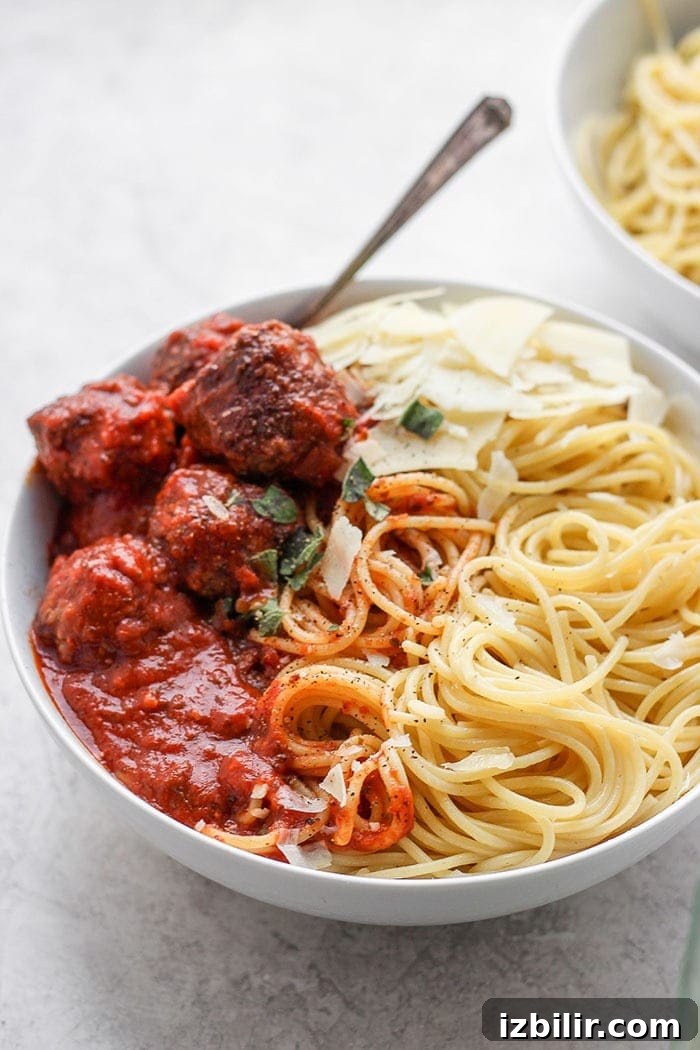 An Italian meatball recipe that the whole family will love. These meatballs are made with ground beef, Italian bread crumbs, and parmesan cheese! Bowl of spaghetti and meatballs.