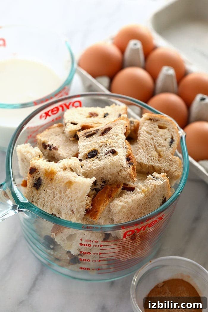 Overnight Cinnamon French Toast Casserole 3 Cinnamon raisin bread in a measuring cup