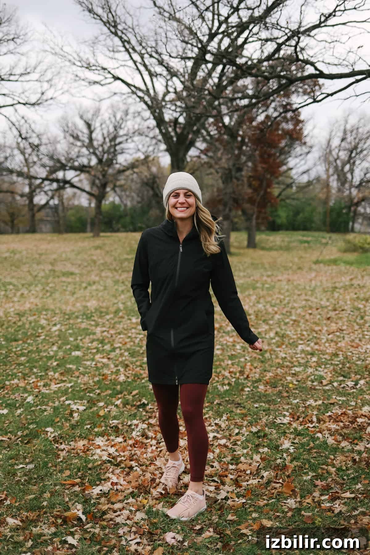 Woman wearing a black jacket and stocking hat