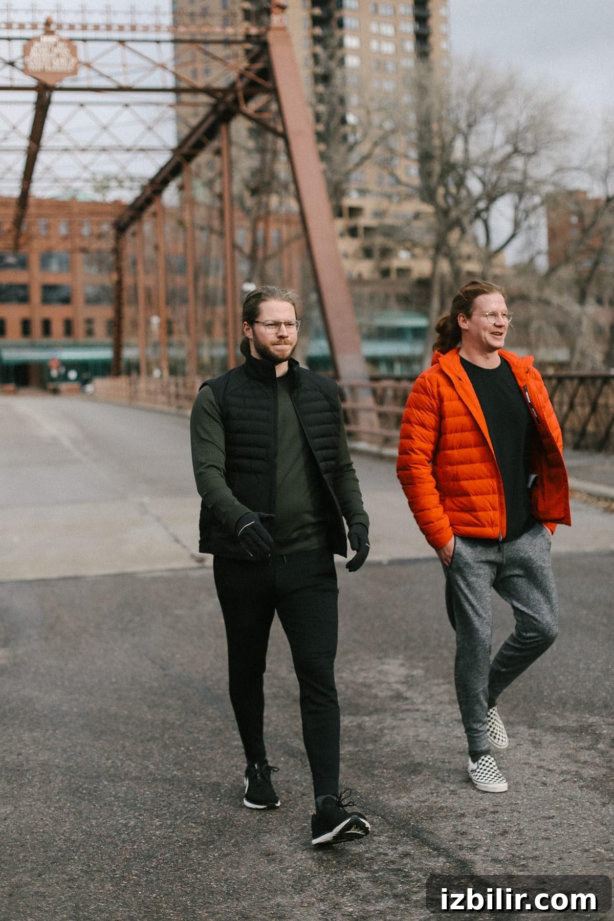 Three men walking across a bridge wearing lululemon gear
