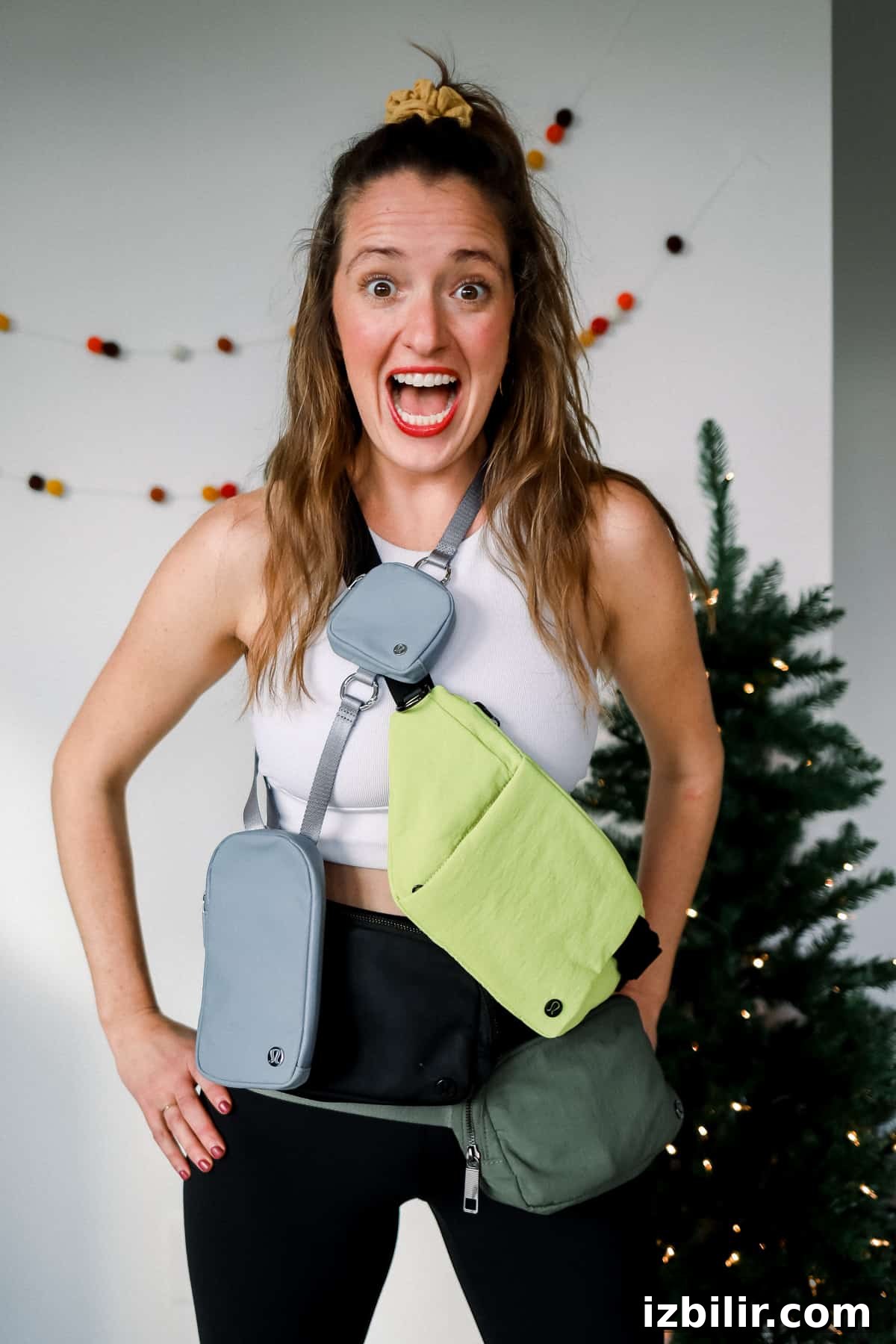 Three women wearing different belt bags and smiling