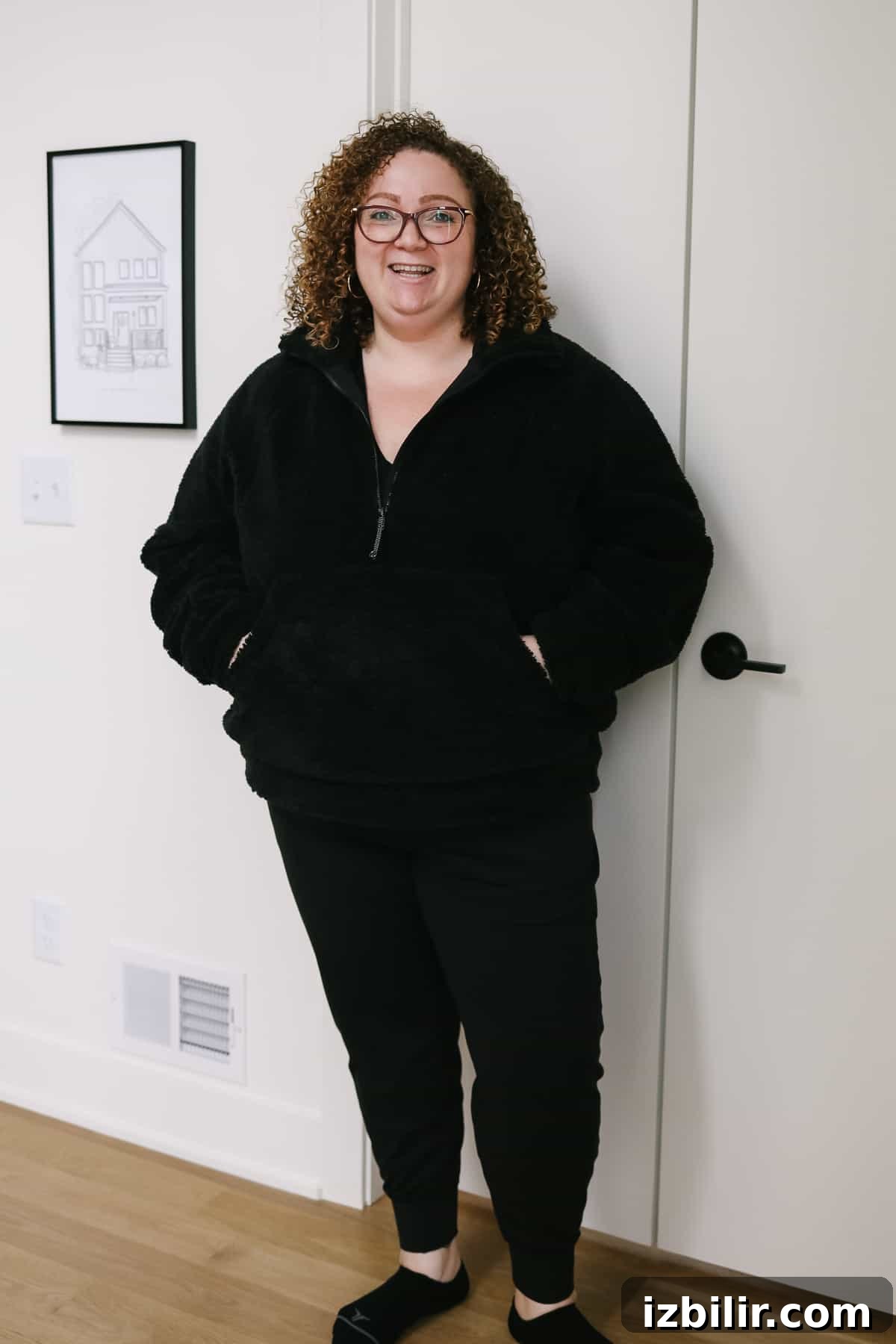 Woman wearing a cozy sherpa zip-up hoodie