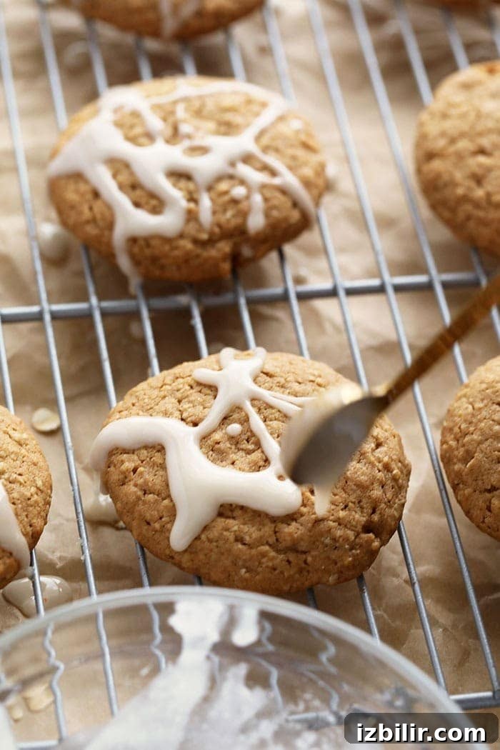 drizzling icing on oatmeal cookie