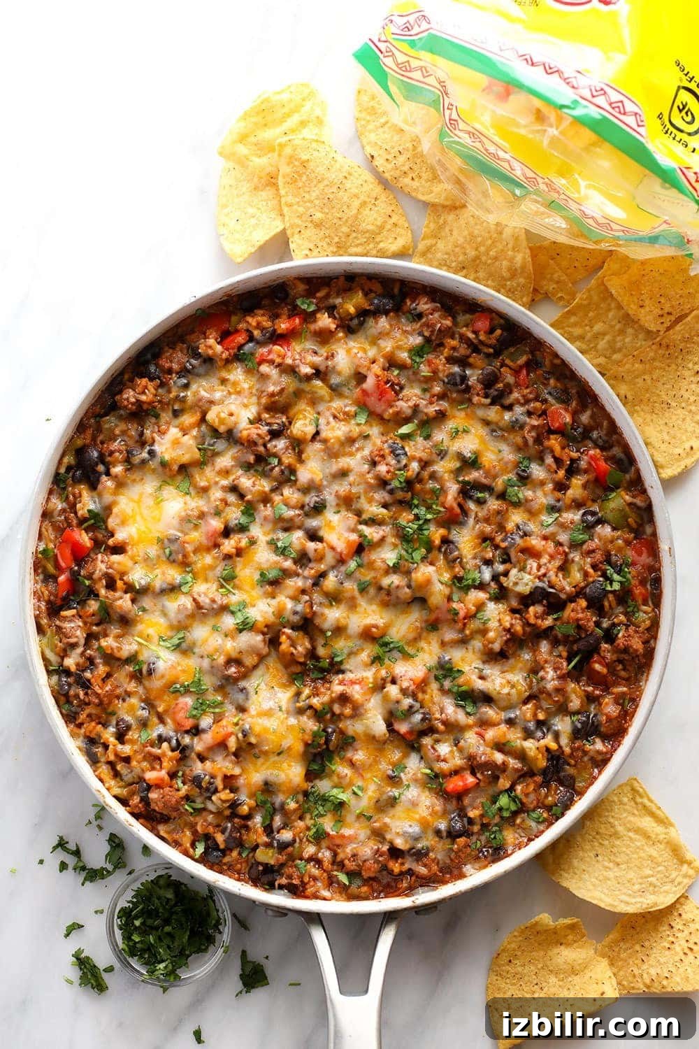 Whether you make this on game day or eat it as a main meal, this Mexican Beef Skillet requires one pan only and only 40 minutes of your time! beef skillet in skillet.