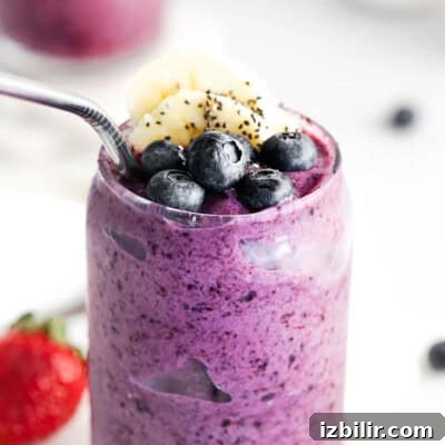 A triple berry smoothie with chia seeds and berries.