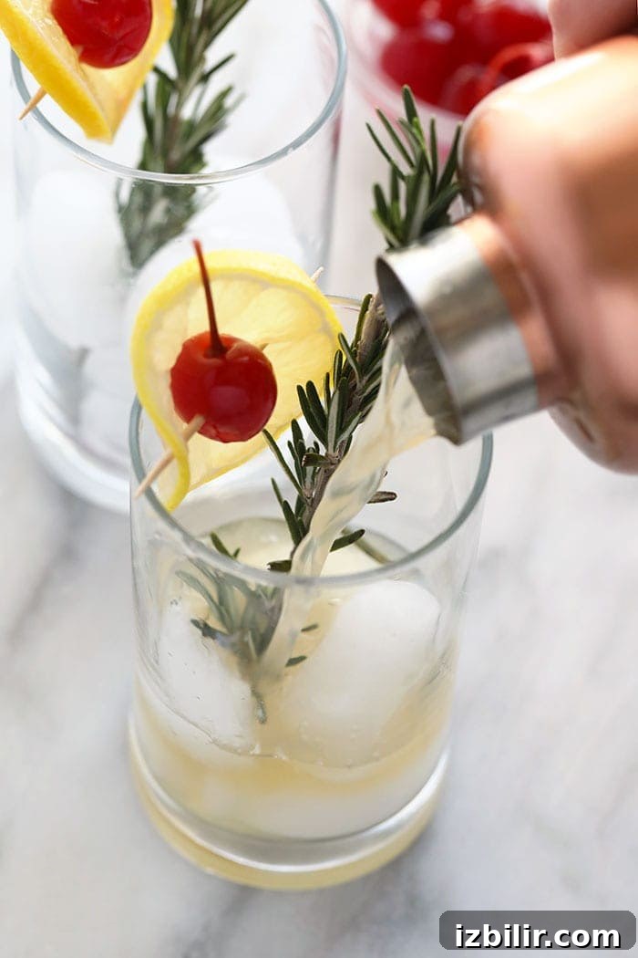 pouring a rosemary collins in a glass