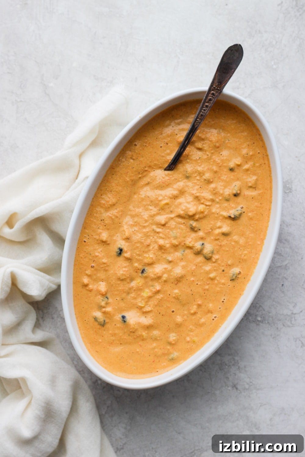 Vegan Street Corn Queso Dip vegan street corn queso dip in a serving bowl with a spoon